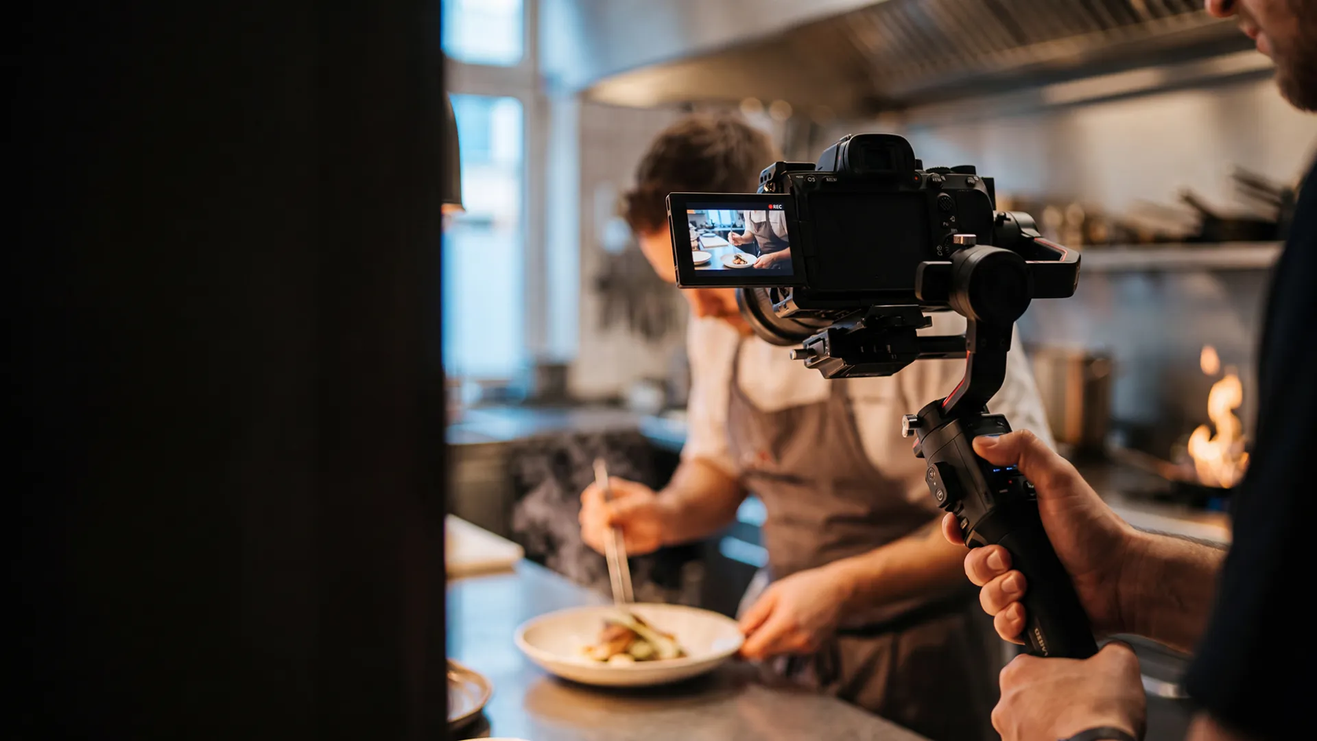 Filming a promotional video in a restaurant kitchen